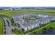 Aerial view of apartment complex with lake views and nearby town center at 7573 Laureate Blvd # 1301, Orlando, FL 32827