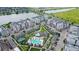 Aerial view showing community layout with swimming pool, tennis court, and surrounding buildings at 7573 Laureate Blvd # 1301, Orlando, FL 32827