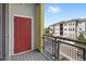 Balcony with a red door and a view of nearby building at 7573 Laureate Blvd # 1301, Orlando, FL 32827