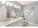 Elegant bathroom features a double sink vanity, granite countertops, modern fixtures and tiled shower at 7573 Laureate Blvd # 1301, Orlando, FL 32827
