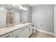 Stylish bathroom featuring double sinks, granite countertops, and modern fixtures and tiled shower at 7573 Laureate Blvd # 1301, Orlando, FL 32827