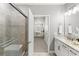 Bathroom featuring shower, granite counters, and tile flooring with a view into the primary bedroom at 7573 Laureate Blvd # 1301, Orlando, FL 32827