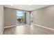 Spacious bedroom with sliding glass doors to a private balcony and wood look tile flooring at 7573 Laureate Blvd # 1301, Orlando, FL 32827