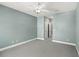Spacious, empty bedroom features neutral walls, new carpet, and a closet and bathroom entrance at 7573 Laureate Blvd # 1301, Orlando, FL 32827