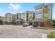 View of the building exterior displaying covered parking, colorful facade, and multiple stories at 7573 Laureate Blvd # 1301, Orlando, FL 32827