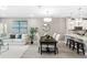 Open concept dining and living room area with dark wood table and seating at 7573 Laureate Blvd # 1301, Orlando, FL 32827