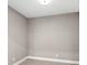 A versatile empty room with neutral walls and wood-look tile floors, ready for customization at 7573 Laureate Blvd # 1301, Orlando, FL 32827