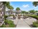 Fire pit with seating surrounded by lush landscaping and palm trees at 7573 Laureate Blvd # 1301, Orlando, FL 32827