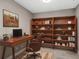 Cozy home office with a classic desk, stylish chair, and built-in shelving for books and decor at 7573 Laureate Blvd # 1301, Orlando, FL 32827