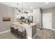 Modern kitchen with an island, stainless steel appliances, white cabinets, and stylish pendant lighting at 7573 Laureate Blvd # 1301, Orlando, FL 32827