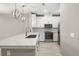 Well-equipped kitchen featuring white cabinets, quartz countertops, and stainless steel appliances at 7573 Laureate Blvd # 1301, Orlando, FL 32827