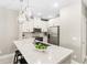 Bright kitchen with stainless appliances, white cabinetry, and a quartz countertop at 7573 Laureate Blvd # 1301, Orlando, FL 32827