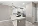 Kitchen island with modern lighting, stainless steel appliances, and countertops at 7573 Laureate Blvd # 1301, Orlando, FL 32827