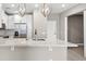 Kitchen island with modern lighting, stainless steel appliances, and bright countertops at 7573 Laureate Blvd # 1301, Orlando, FL 32827