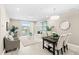 Bright living room with open dining area, balcony access, modern furniture and stylish decor at 7573 Laureate Blvd # 1301, Orlando, FL 32827