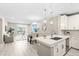 Open-concept living room with modern kitchen, dining area, and balcony access at 7573 Laureate Blvd # 1301, Orlando, FL 32827