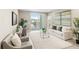 Bright living room featuring a balcony, comfortable seating, and modern décor at 7573 Laureate Blvd # 1301, Orlando, FL 32827