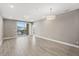 Open living space with balcony, and wood-look tile floors, bathed in bright, natural light at 7573 Laureate Blvd # 1301, Orlando, FL 32827