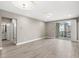 Bright living room with access to a balcony, offering community views at 7573 Laureate Blvd # 1301, Orlando, FL 32827