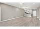 Spacious living area featuring modern lighting, open floorplan and light wood look flooring at 7573 Laureate Blvd # 1301, Orlando, FL 32827