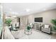 Open-concept living room features modern furniture, stylish decor, and views into the kitchen at 7573 Laureate Blvd # 1301, Orlando, FL 32827