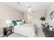 Inviting primary bedroom with a plush bed, ceiling fan, and tranquil ambiance at 7573 Laureate Blvd # 1301, Orlando, FL 32827