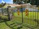 A decorative gold lion themed gate at the front of the property adds security and curbside appeal at 11543 Se 58Th Ct, Belleview, FL 34420