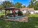 A backyard hot tub beneath a pergola offers a luxurious outdoor retreat at 11543 Se 58Th Ct, Belleview, FL 34420