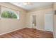 Bright bedroom boasts hardwood floors, an arch window and access to the ensuite bathroom at 1611 Sand Key Cir, Oviedo, FL 32765