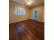 Bright bedroom boasts hardwood floors and access to the ensuite bathroom at 1611 Sand Key Cir, Oviedo, FL 32765
