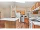 Eat in kitchen featuring island, white appliances, and tiled flooring at 1611 Sand Key Cir, Oviedo, FL 32765