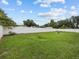 Large grassy backyard with a white privacy fence at 7438 Floral W Cir, Lakeland, FL 33810