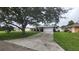 House exterior with a long driveway and green grass at 7438 Floral W Cir, Lakeland, FL 33810