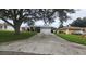 Front view of a house with a driveway and a tree at 7438 Floral W Cir, Lakeland, FL 33810