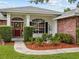 Welcoming front entrance with red door and landscaping at 7438 Floral W Cir, Lakeland, FL 33810