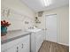 Bright laundry room with washer, dryer, and built-in shelving at 7438 Floral W Cir, Lakeland, FL 33810