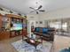 Living room featuring leather couches and a large entertainment center at 7438 Floral W Cir, Lakeland, FL 33810