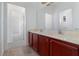 Double vanity bathroom with marble countertop and view of another room at 10064 Silver Laurel Way, Orlando, FL 32832