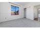 Bright bedroom with gray carpet, a closet, and a window with a view at 10064 Silver Laurel Way, Orlando, FL 32832