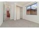 Bedroom with grey carpet, closet, and kitchen view at 10064 Silver Laurel Way, Orlando, FL 32832