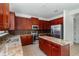 Kitchen with granite countertops, stainless steel appliances, and wood cabinets at 10064 Silver Laurel Way, Orlando, FL 32832