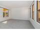 Bright living room with large windows, neutral walls, and carpet flooring at 10064 Silver Laurel Way, Orlando, FL 32832