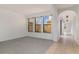 Bright living room with large windows, neutral walls, and carpet flooring at 10064 Silver Laurel Way, Orlando, FL 32832