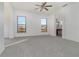 Spacious main bedroom with a ceiling fan, large windows and carpet flooring at 10064 Silver Laurel Way, Orlando, FL 32832