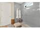 Modern bathroom with a glass-enclosed shower featuring gray tiling and bright natural light at 16161 Parkwyn St, Winter Garden, FL 34787