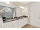 Elegant bathroom features double sinks with granite countertops, white cabinetry and a large mirror at 16161 Parkwyn St, Winter Garden, FL 34787