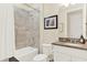 Bathroom featuring tiled shower, granite counters, vanity, and framed wall art at 16161 Parkwyn St, Winter Garden, FL 34787