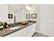 Bathroom featuring double vanity with granite counters, and white cabinets at 16161 Parkwyn St, Winter Garden, FL 34787