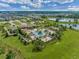 A community pool and amenity center nestled into a green lawn with neighborhood ponds, and residences in the distance at 16161 Parkwyn St, Winter Garden, FL 34787