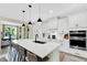 Modern kitchen featuring quartz countertops, an island with seating, and stainless steel appliances at 16161 Parkwyn St, Winter Garden, FL 34787